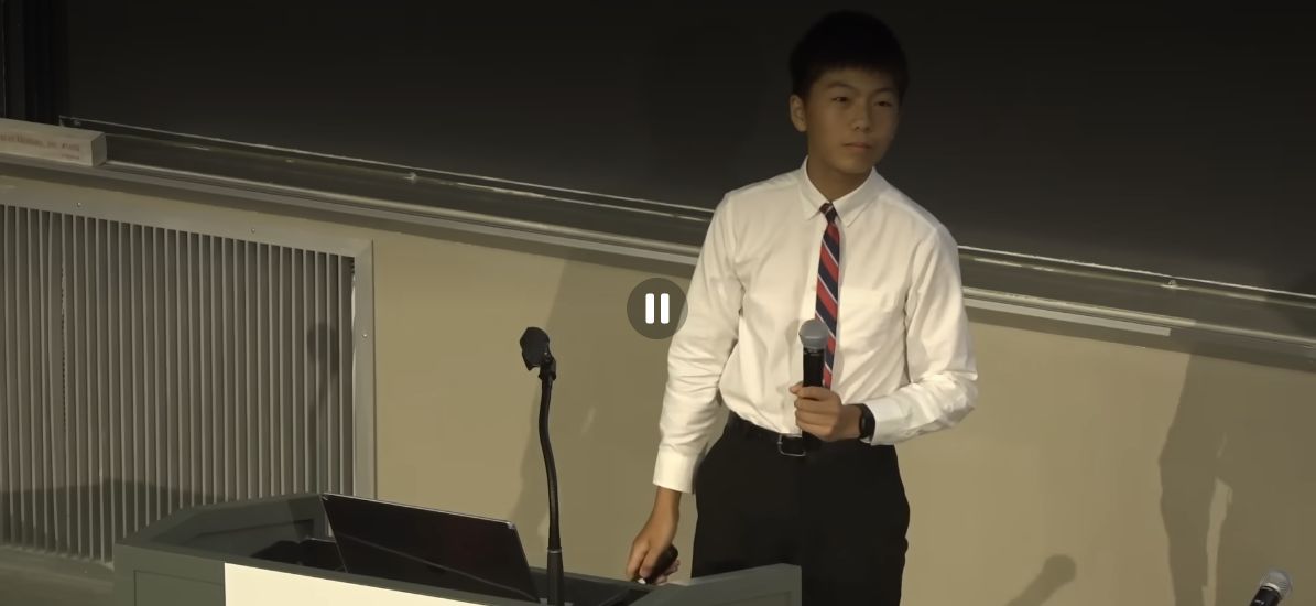 Cody Li presenting RehabAI on stage at MIT.